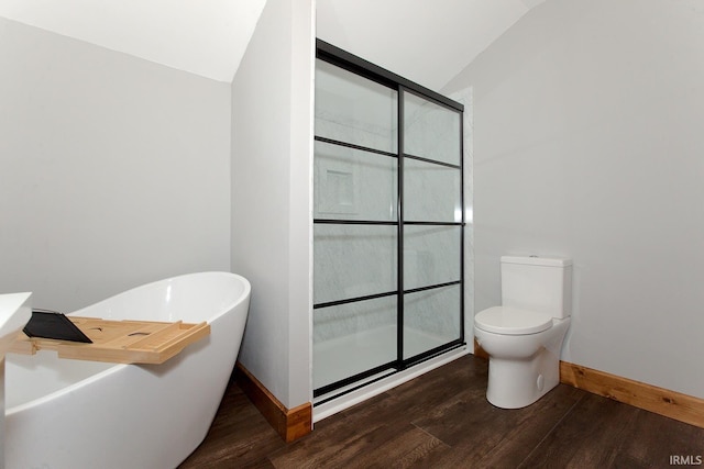 full bath featuring a freestanding tub, vaulted ceiling, wood finished floors, and a walk in shower