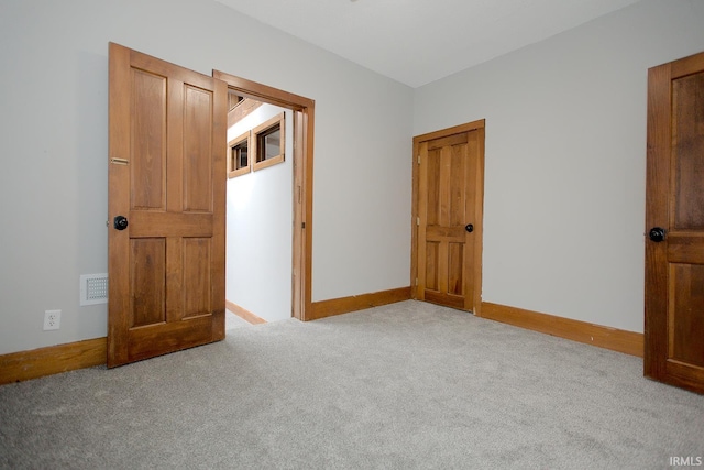 unfurnished bedroom with carpet and baseboards