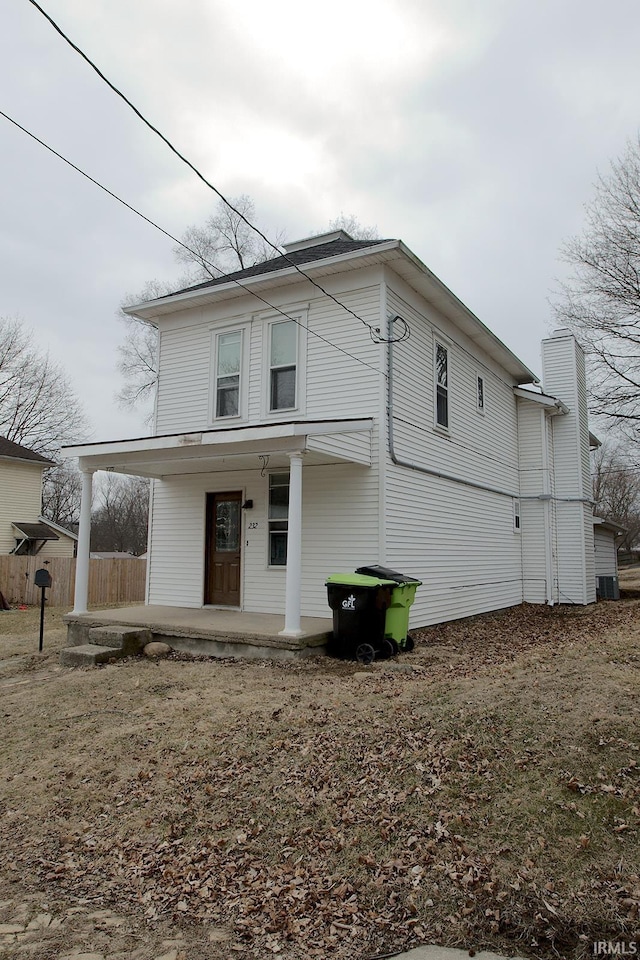 exterior space featuring a porch and fence