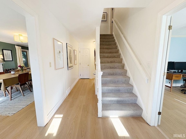 stairs featuring baseboards and wood finished floors