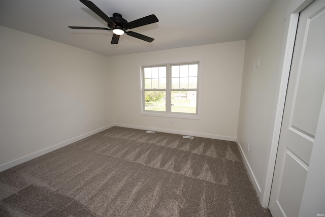 3337 Blarney Dr, South Bend, IN 46628 - empty room with dark carpet, baseboards, and a ceiling fan
