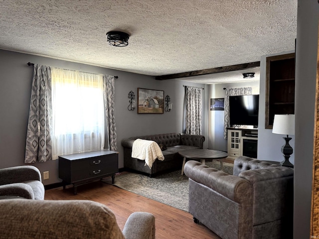 living area with a textured ceiling and wood finished floors