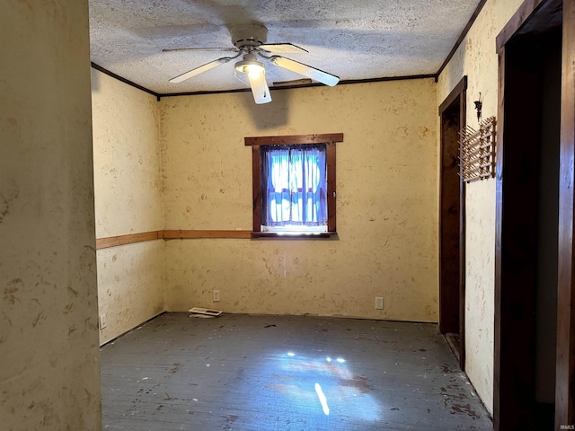 empty room featuring crown molding, a ceiling fan, and a textured ceiling