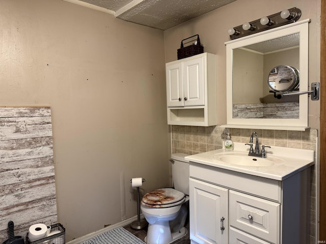 half bath featuring baseboards, decorative backsplash, toilet, a textured ceiling, and vanity