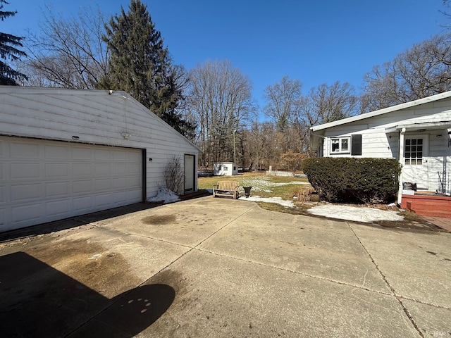 exterior space with a garage, an outdoor structure, and driveway