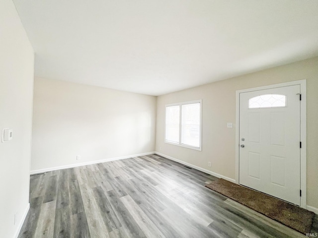 entryway with wood finished floors, visible vents, and baseboards