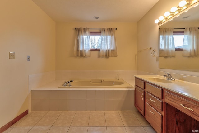 full bathroom with a healthy amount of sunlight, vanity, a bath, and tile patterned floors