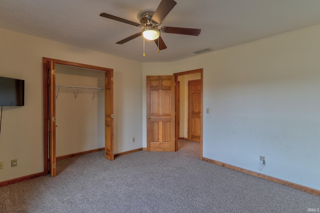 unfurnished bedroom with a closet, light colored carpet, visible vents, a ceiling fan, and baseboards