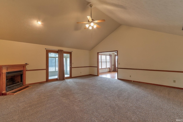 unfurnished living room featuring a fireplace with raised hearth, high vaulted ceiling, light colored carpet, a ceiling fan, and baseboards