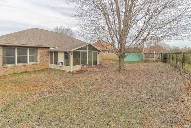 view of yard with a fenced backyard and a sunroom