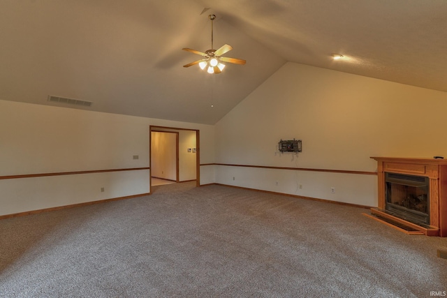 unfurnished living room featuring a fireplace with raised hearth, carpet floors, visible vents, baseboards, and a ceiling fan