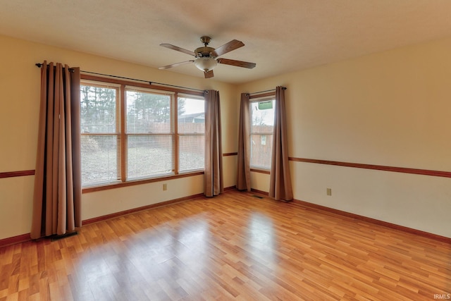 empty room with baseboards and light wood-style floors