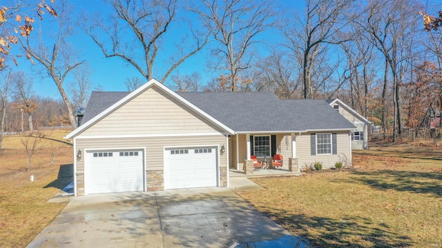 view of front of home with a garage, concrete driveway, stone siding, a porch, and a front yard