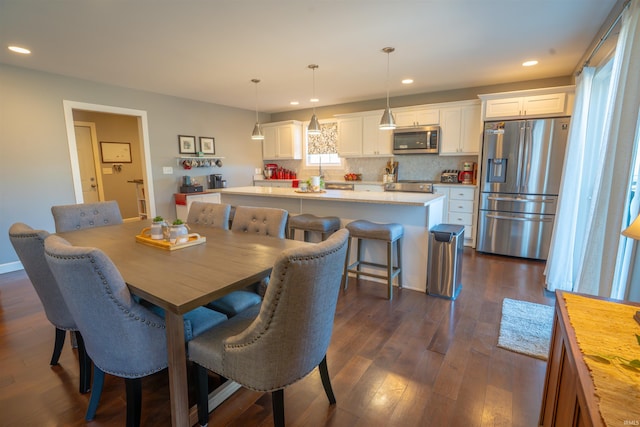 dining area with recessed lighting and dark wood finished floors