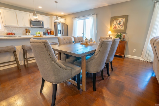 dining area featuring dark wood-type flooring, recessed lighting, and baseboards