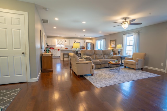 living area with baseboards, visible vents, dark wood finished floors, a ceiling fan, and recessed lighting