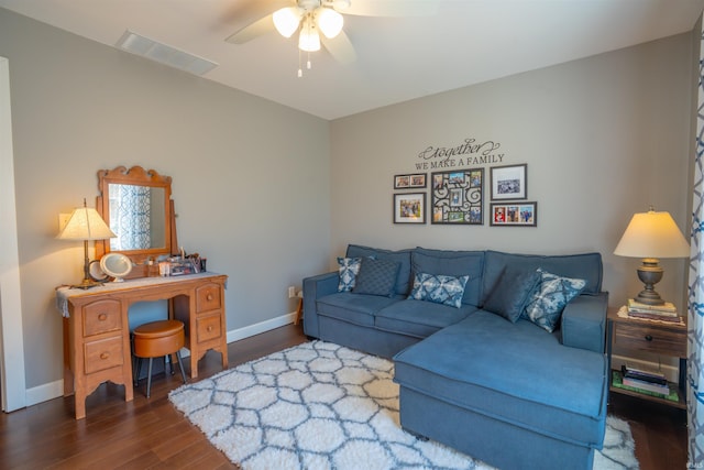 living area with a ceiling fan, baseboards, visible vents, and wood finished floors