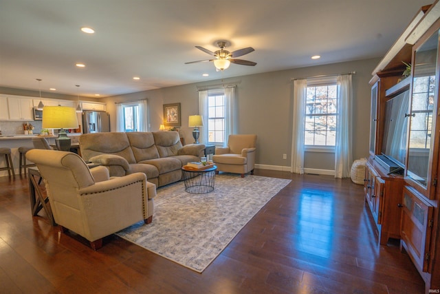 living area featuring a ceiling fan, recessed lighting, dark wood finished floors, and baseboards