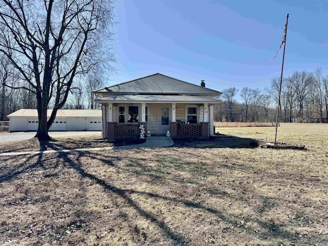 view of front facade featuring a porch, a front yard, and brick siding