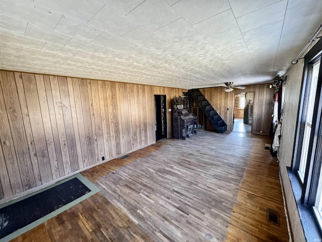 interior space featuring ceiling fan, wood finished floors, visible vents, and baseboards