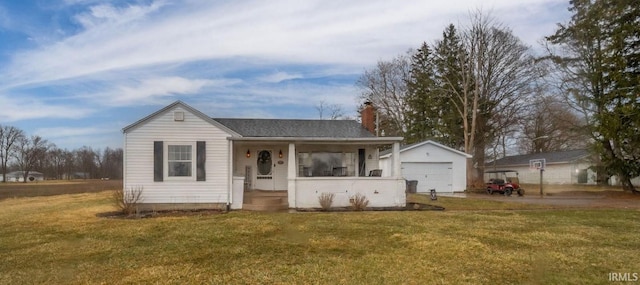 view of front of property with a chimney, a porch, a detached garage, an outdoor structure, and a front lawn