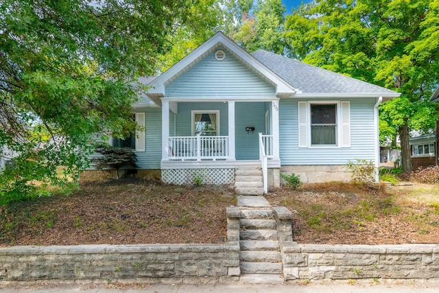 bungalow-style house with covered porch and a shingled roof