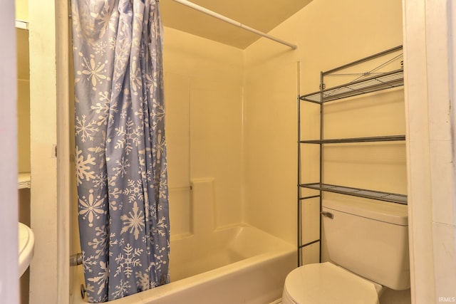 bathroom with shower / tub combo and toilet