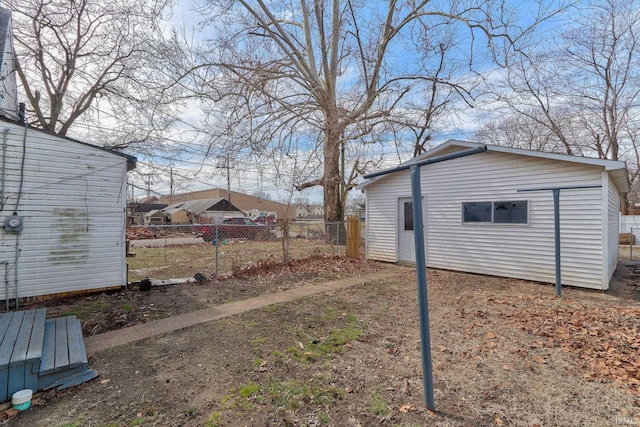 view of yard featuring fence and an outdoor structure