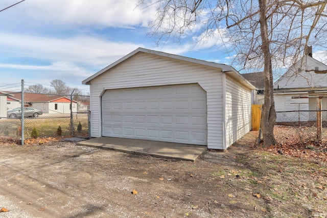 detached garage featuring fence