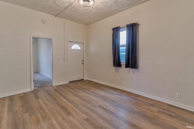 entrance foyer with baseboards and wood finished floors