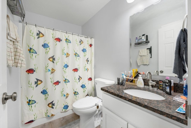 bathroom featuring shower / bath combination with curtain, vanity, and toilet