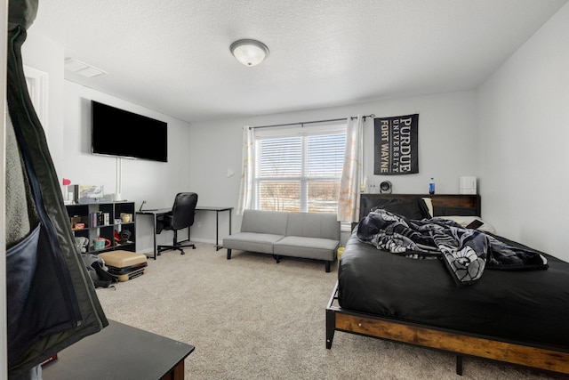 bedroom featuring a textured ceiling, visible vents, and carpet flooring