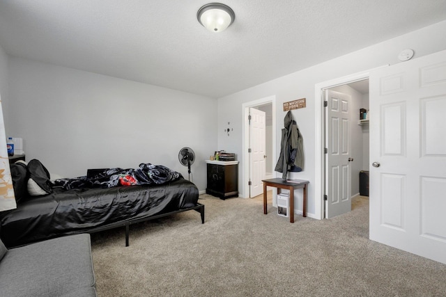 bedroom featuring carpet floors and a textured ceiling