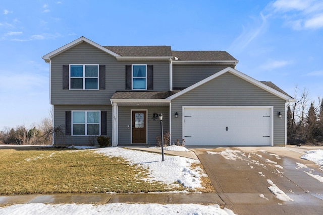 view of front facade featuring a garage, a yard, and driveway