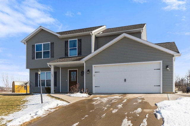 view of front of home with an attached garage, driveway, and roof with shingles