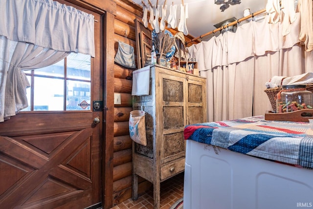 bedroom with brick floor and rustic walls