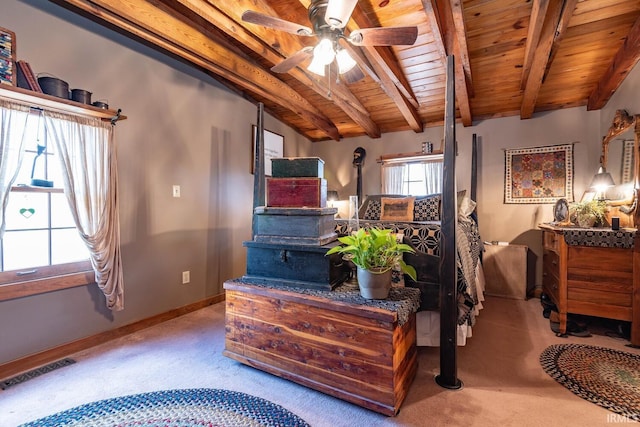 carpeted bedroom featuring ceiling fan, vaulted ceiling with beams, wood ceiling, baseboards, and visible vents