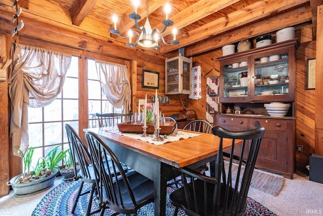 dining room with wood ceiling, wooden walls, beam ceiling, and a notable chandelier