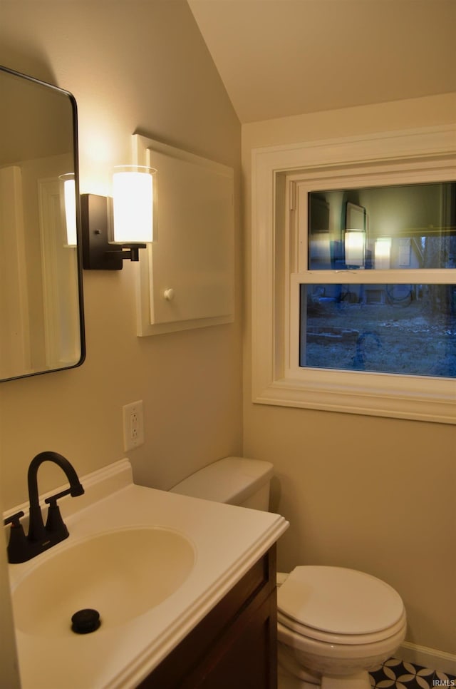 bathroom featuring vaulted ceiling, vanity, and toilet