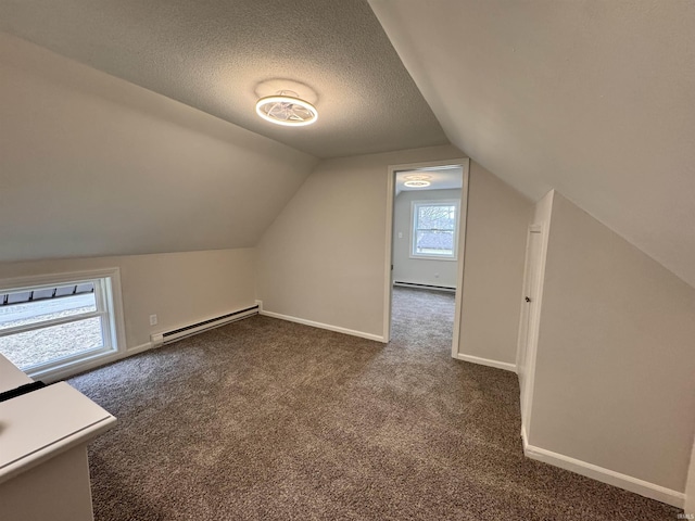 bonus room featuring a baseboard radiator, a baseboard heating unit, dark carpet, and baseboards