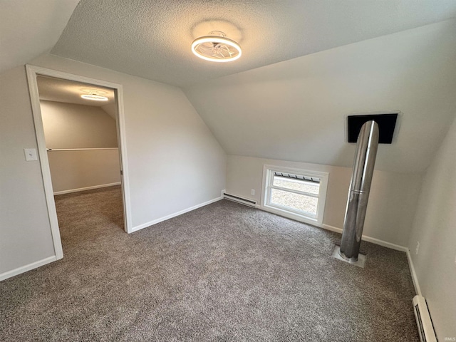 bonus room with lofted ceiling, baseboards, a textured ceiling, and baseboard heating