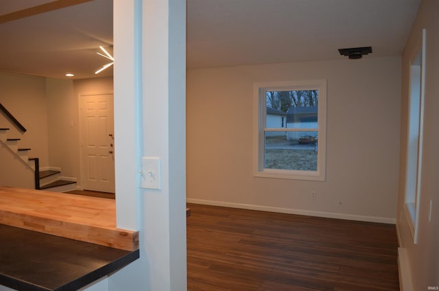 interior space featuring wood finished floors and baseboards