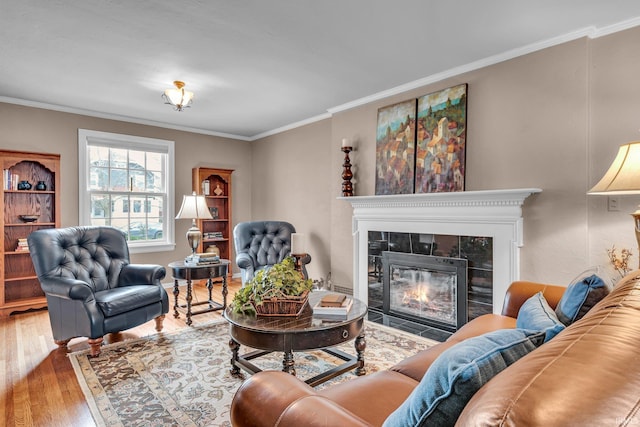 living area featuring crown molding, a fireplace, and hardwood / wood-style floors