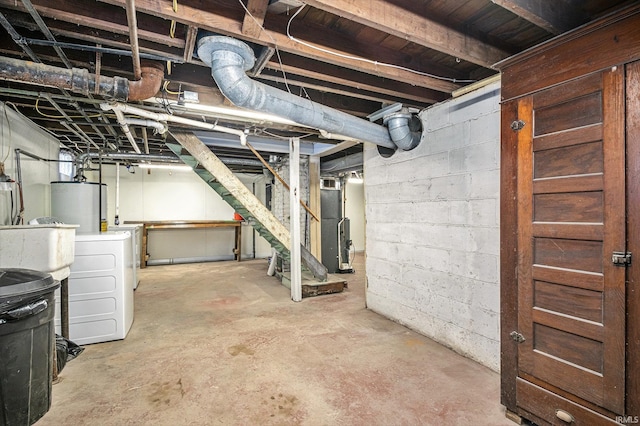 unfinished basement featuring stairs, washer and dryer, and gas water heater