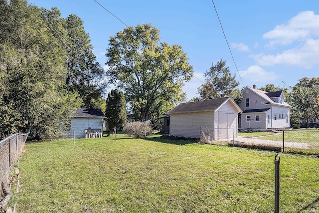 view of yard with an outbuilding, a fenced backyard, and a storage shed