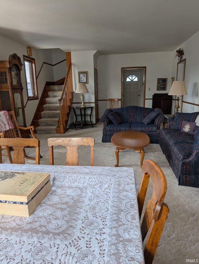 carpeted living room with stairway