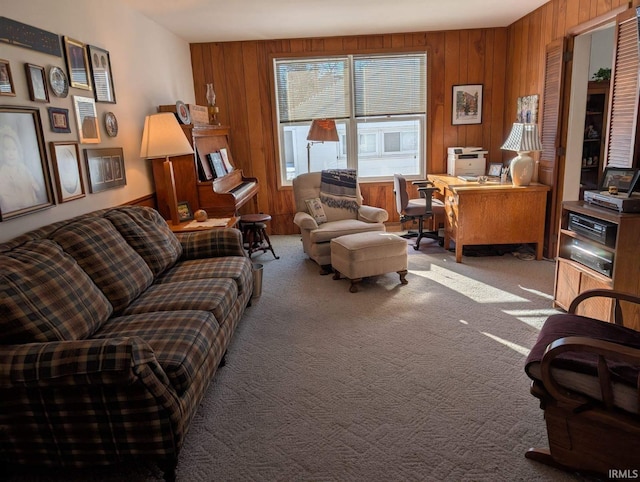 living area featuring carpet and wooden walls