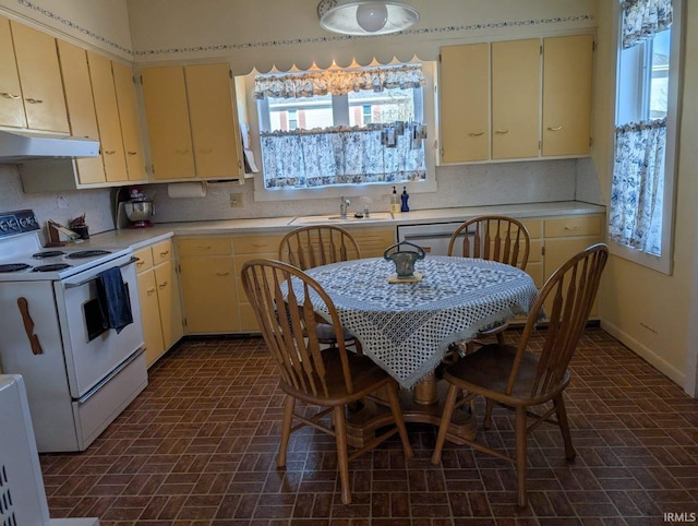 kitchen featuring white electric range oven, under cabinet range hood, light countertops, and a sink