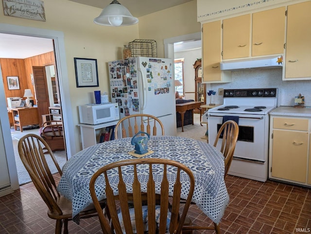 dining space with brick patterned floor