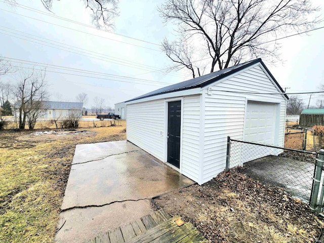 view of outdoor structure featuring an outbuilding and fence